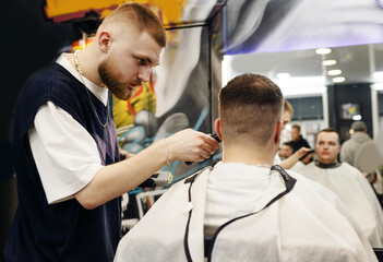 Men's haircut with hairdressing scissors. Men's hair salon