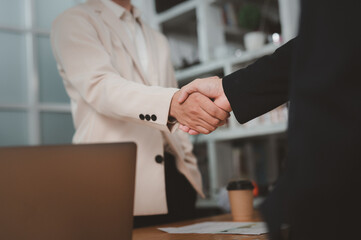 Man and man are shaking hands in office. Collaborative teamwork.
