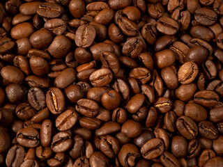 Background from roasted coffee beans. Scattered coffee beans. Coffee beans close up.