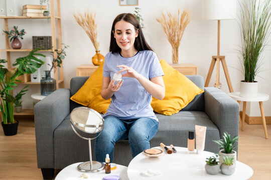 Woman Doing Makeup In The Living Room At Home.