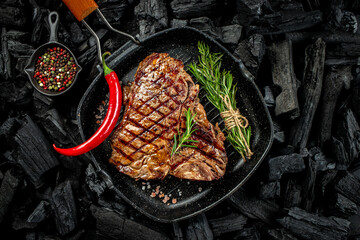 T-bone or porterhouse grilled beef steak with spices and herbs. Restaurant menu, cookbook recipe....