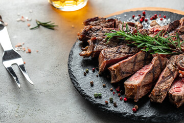T-bone or porterhouse grilled beef steak with spices and herbs. Long banner format. top view
