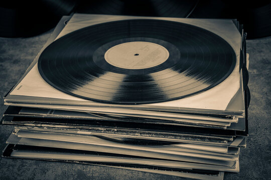Vintage vinyl record on grunge background, retro toned.