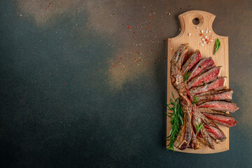 Sliced grilled beef barbecue Striploin steak on a wooden board, Restaurant menu, dieting, cookbook recipe top view