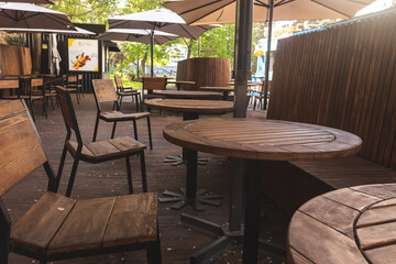 Empty cafe terrace with tables and chairs. Exterior of cafe restaurant.