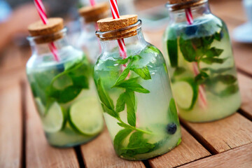 Cold refreshing limonade, mojito or gin tonic in glass, with fresh mint and ice cubes