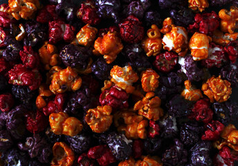 multi-colored popcorn in caramel glaze scattered as a background