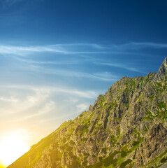 Fototapeta na wymiar mount slope on dramatic sunset background