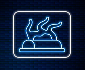 Glowing neon line Campfire icon isolated on brick wall background. Burning bonfire with wood. Vector