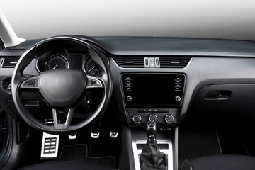 Modern black car interior, leather steering wheel, climate control, navigation, deflectors on the...