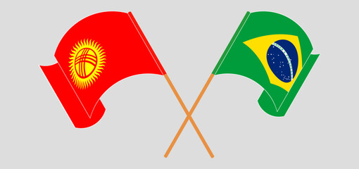 Crossed and waving flags of Kyrgyzstan and Brazil