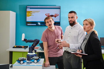  A group of students working together in a laboratory, dedicated to exploring the aerodynamic capabilities of a drone