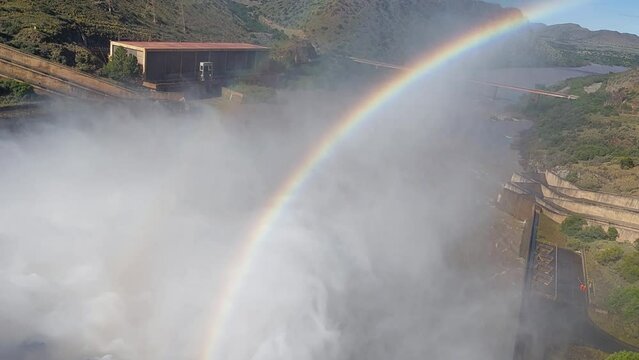 The Gariep Dam overflowing. A rainbow is visible