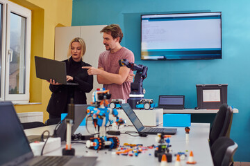 A group of colleagues working together in a robotics laboratory, focusing on the intricate fields of robotics and 3D printing. Showcase their dedication to innovation, as they engage in research