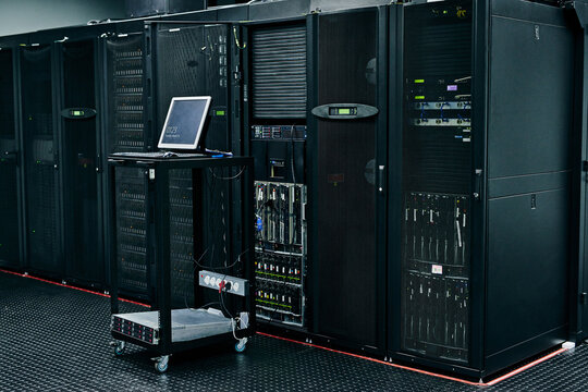 Server room, empty or laptop for internet connection, cloud computing network or cyber security hardware. IT support background, information technology or cord on machine equipment in a data center