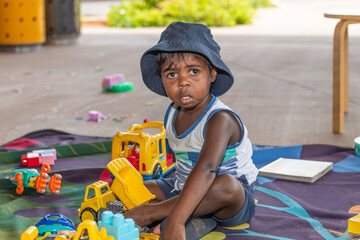 Aboriginal child playing with toys