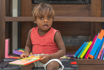 Aboriginal Toddler reading books