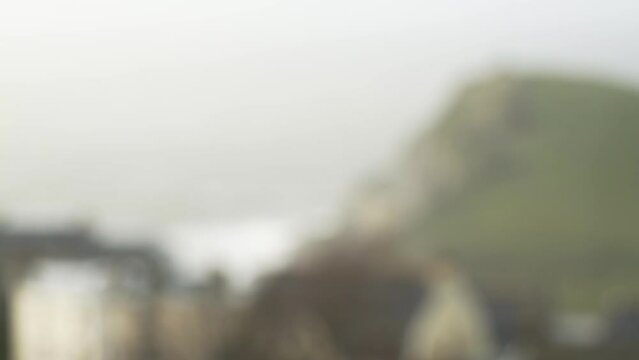 Rain drops flying by with blurred ocean in background