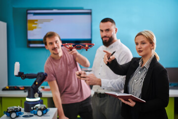  A group of students working together in a laboratory, dedicated to exploring the aerodynamic capabilities of a drone