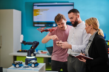  A group of students working together in a laboratory, dedicated to exploring the aerodynamic capabilities of a drone