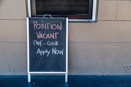 Sign outside pub saying position vacant chef cook apply now