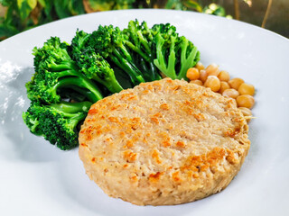 Vegan food concept. Plant-based meat grill served with chickpeas and boiled broccoli. Source of fiber. Healthy and sustainable meal.