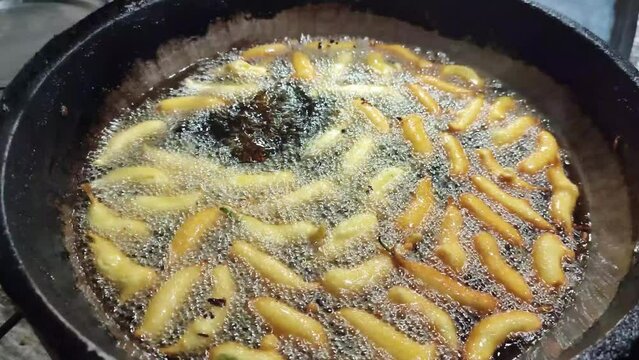 Street food of Bangladesh. Green Chilli Fry with Chickpea flour. Fried with soybean oil.