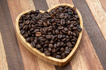 coffee beans in heart-shaped tra,y representing love of coffee