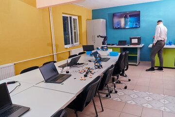 A man working in a robotics laboratory, focusing on the intricate fields of robotics and 3D printing. Showcase their dedication to innovation, as they engage in research, development, engineering, and