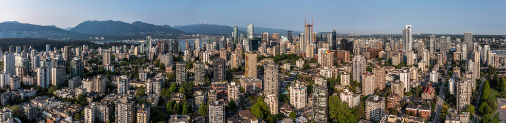 Fototapeta na wymiar panoramic aerial city view of Downtown Vancouver in British Columbia, Canada with skyscrapers and buildings in front and mountains in background 