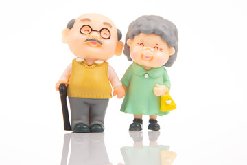 miniature people. figures for the concept. a couple of pensioners walk together. attitude and friendship in old age