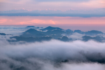 Fototapeta na wymiar Aiyerweng sea of mist with the mountains during sunrise time. The largest and most beautiful mist in the south of Thailand , Aiyerweng , Betong district , Yala province Thailand.