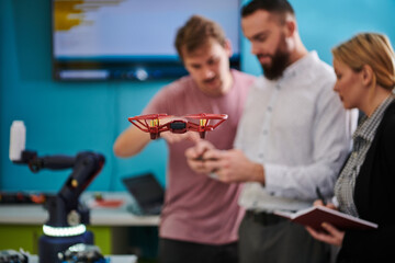  A group of students working together in a laboratory, dedicated to exploring the aerodynamic capabilities of a drone