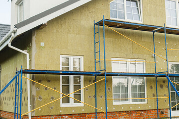 House insulation concept. Facade insulation with mineral wool, thermal improvement and energy...