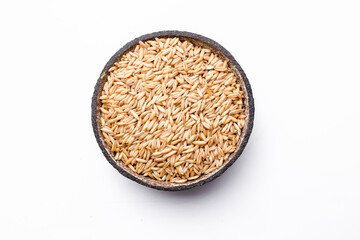oat seeds in a black plate isolated on white background top view