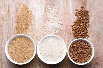 Rice, buckwheat, amaranth seeds. Gluten free seeds in bowls. Top view with copyspace.