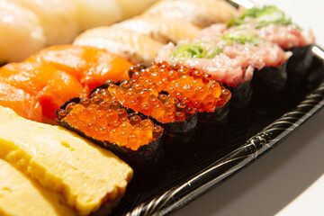 Different types of sushi on a plate	