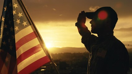 Silhouette of Military Salute of soldier for memorial day against flag at sunset