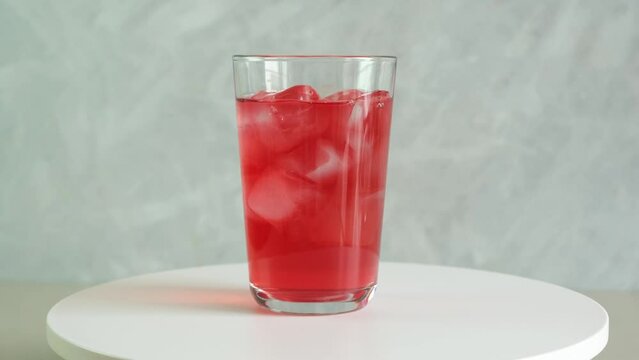Refreshing summer iced drink, rotation moving. Rose cold cocktail. Red fruit ice tea. Glass of Ovshala lemonade.