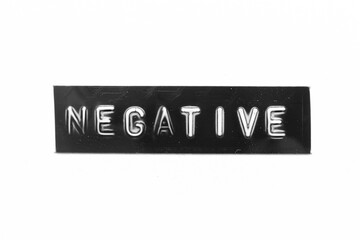 Black color banner that have embossed letter with word negative on white paper background