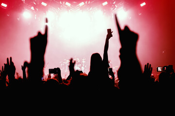 Fototapeta premium Audience with raised hands on a dance floor at a music festival.