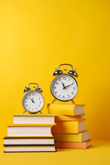 stack of books and clock on yellow background created with AI generative technology