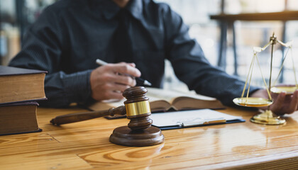 Lawyer reading a book and working in a law firm, Legal counsel and justice concept.