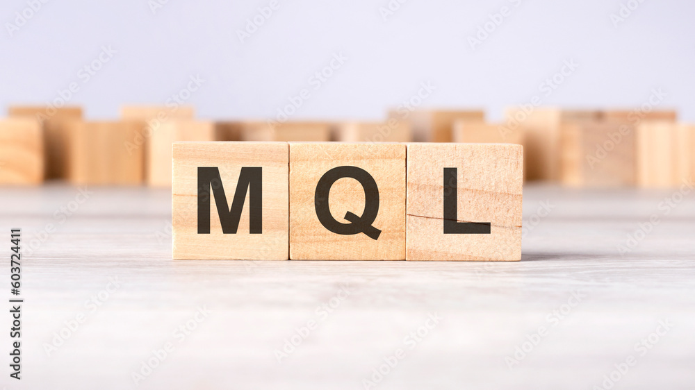 Poster mql - word concept written on wooden cubes or blocks on a light background