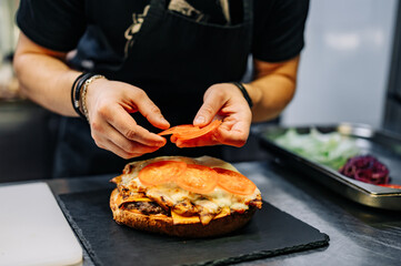 chef hand cooking big large cheese burger on restaurant kitchen. step by step