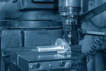 Part centering operation on NC milling machine with automotive parts.