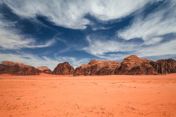Fototapeta na wymiar Amazing and spectacular landscapes of Wadi Rum desert in Jordan. Dunes, rocks, it's all here. Beautiful weather gives the climate to this place.