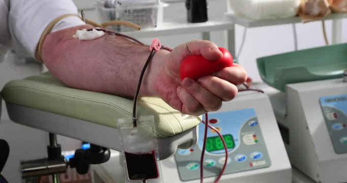 Health care and charity. Also a concept image of the background for World Blood Donor Day - 14 June..Man donating blood, close-up - test
