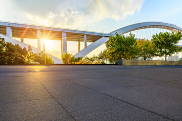 Empty square floor and bridge building scene at sunset