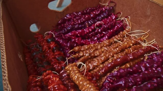 Churchkhela is a traditional georgian homemade sweets with nuts and grape juice on the local food market. High quality FullHD footage